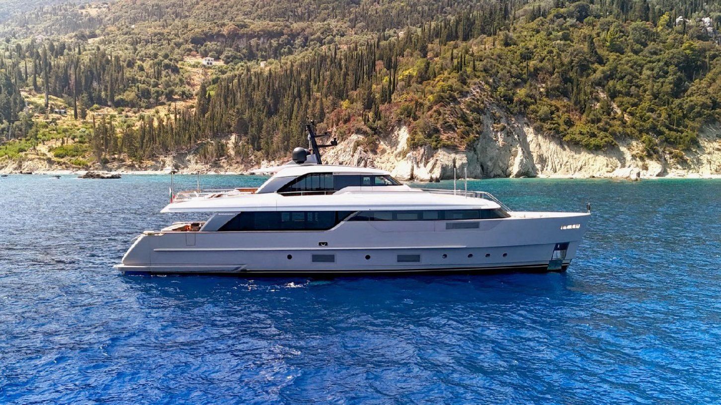 FLORI at anchor near a wooded coast