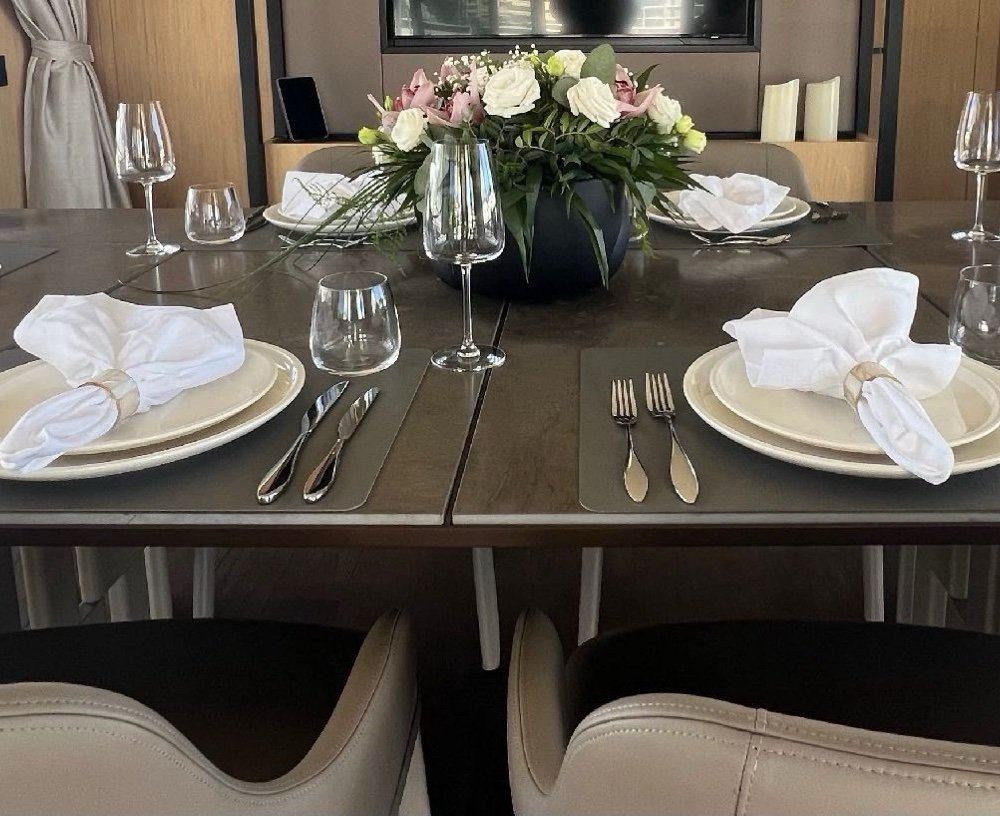 Dining table place settings with floral centrepiece