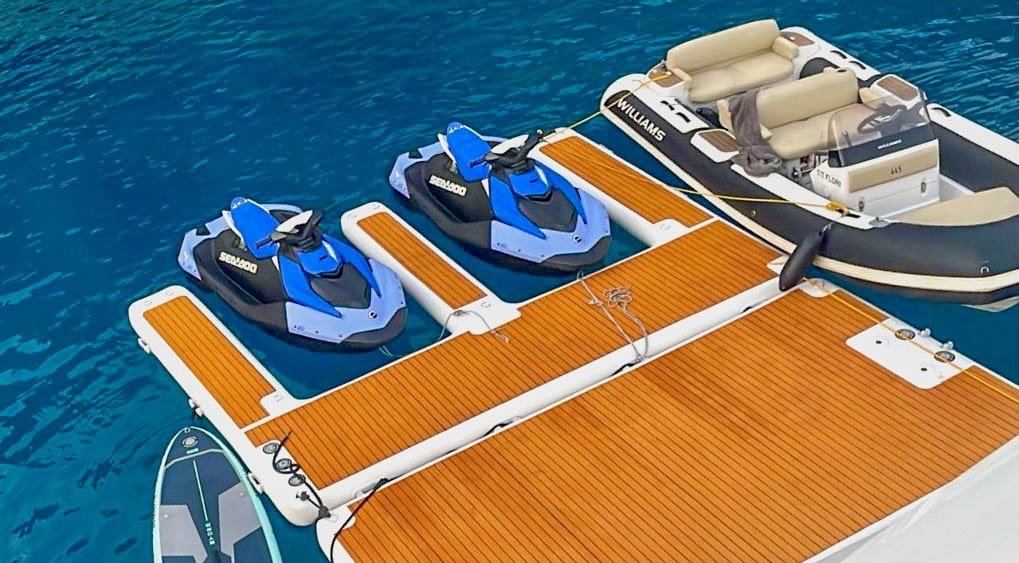 Jet skis and tender at the sea dock
