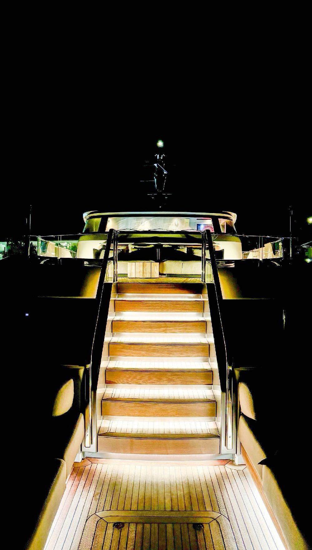 Aft deck stairway illuminated at night
